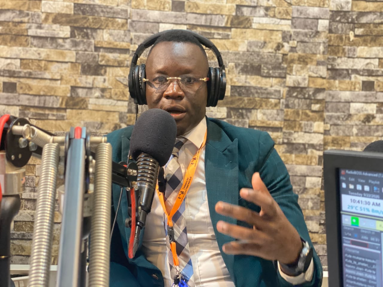 Advocate Emmanuel Sumagule Benaih Swaka, ILA Executive Director, speaking into a microphone during the radio talk show.