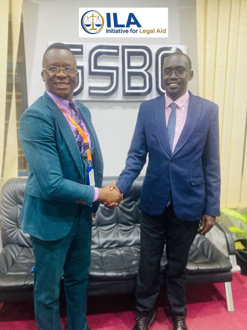 Advocate Emmanuel Sumagule Benaih Swaka, ILA Executive Director, shakes hands with an SSBC representative.