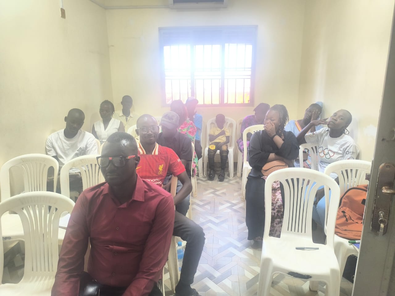 Community members seated in a training room during an ILA leadership and human rights training session.