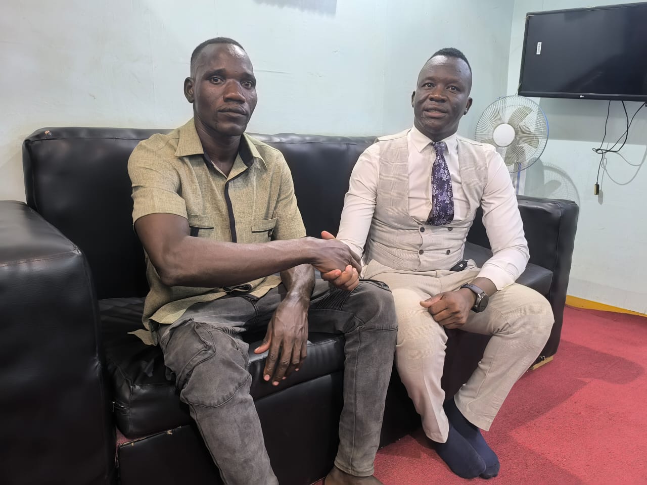 An ILA legal officer and a client seated together at the ILA office.