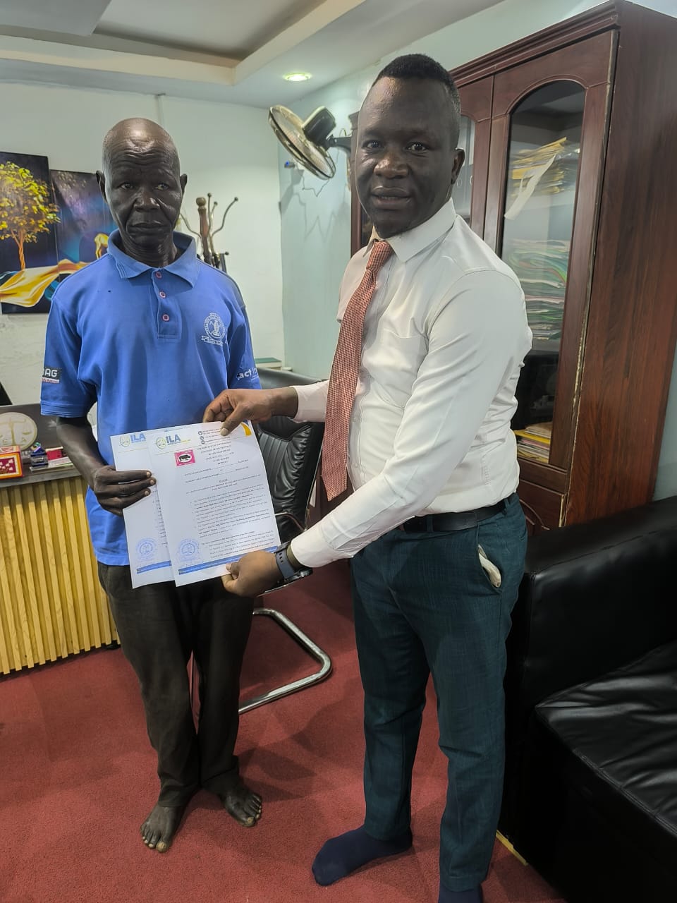 An ILA representative in conversation with a client at the ILA office.